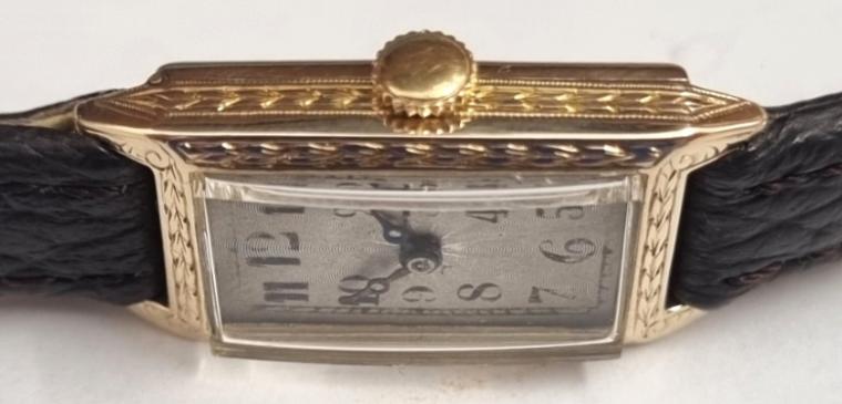 Ladies Vintage Rolex Genex wrist watch in an oblong 9ct gold case with Glasgow import hallmark for c1926 on a brown leather strap with gilt buckle. Silvered dial with black hours and blued steel Breguet style moon hands. Swiss signed Genex 15 jewel jewelled lever movement with case back signed 'R.W.C. Ltd' and externally numbered 550 24318.