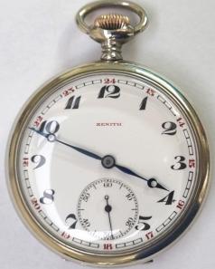 Swiss Zenith pocket watch with top wind and time change in white metal case with gilt crown c1900. Signed white enamel dial with black numeric hours and red military style 24 hour marking with blued steel hands and subsidiary seconds dial at 6 o/clock. Swiss signed jewelled lever movement with split bi-metallic balance and overcoil hairspring numbered 1469863 with the signed case back numbered 5197863.