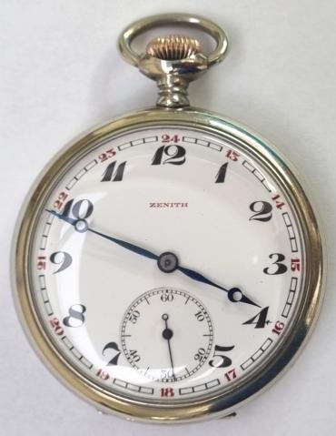 Swiss Zenith pocket watch with top wind and time change in white metal case with gilt crown c1900. Signed white enamel dial with black numeric hours and red military style 24 hour marking with blued steel hands and subsidiary seconds dial at 6 o/clock. Swiss signed jewelled lever movement with split bi-metallic balance and overcoil hairspring numbered 1469863 with the signed case back numbered 5197863.