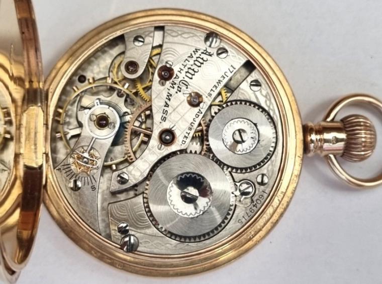 American Waltham Watch Co., full hunter presentation pocket watch in a 9ct gold Dennison case numbered 12317 and hallmarked for Birmingham c1907. Top wind and time change with inscribed outer case over a white enamel dial with black Roman hours and blued steel hands with a subsidiary seconds dial at 6 o/c. American Waltham 17 jewel adjusted jewelled lever movement with split bi-metallic balance and overcoil hairspring with micro-adjuster and numbered 16049715. The inner case cover recording a personal presentation on March 31st 1909.