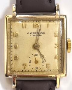Swiss made J.W.Benson tank style hand wind wrist watch in a 9ct gold Dennison case with Birmingham hallmark for c1950, on a brown leather strap with gilt buckle. Signed cream dial with polished gilt numeric hours and matching hands with subsidiary seconds dial at 6 o/c. Swiss Cyma signed J.W.Benson 15 jewel jewelled lever movement with bi-metallic balance and numbered 241000 with signed 15125 case back numbered 307083..