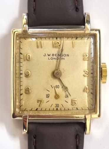 Swiss made J.W.Benson tank style hand wind wrist watch in a 9ct gold Dennison case with Birmingham hallmark for c1950, on a brown leather strap with gilt buckle. Signed cream dial with polished gilt numeric hours and matching hands with subsidiary seconds dial at 6 o/c. Swiss Cyma signed J.W.Benson 15 jewel jewelled lever movement with bi-metallic balance and numbered 241000 with signed 15125 case back numbered 307083.