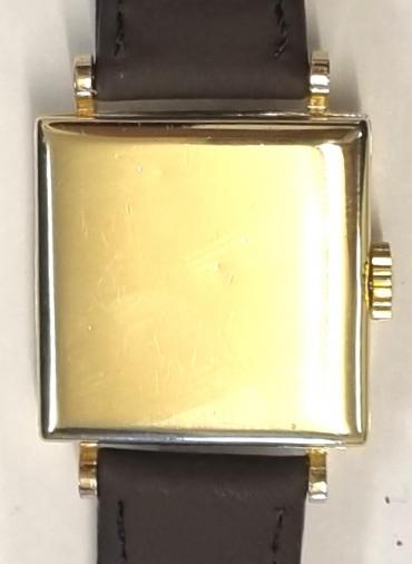 Swiss made J.W.Benson tank style hand wind wrist watch in a 9ct gold Dennison case with Birmingham hallmark for c1950, on a brown leather strap with gilt buckle. Signed cream dial with polished gilt numeric hours and matching hands with subsidiary seconds dial at 6 o/c. Swiss Cyma signed J.W.Benson 15 jewel jewelled lever movement with bi-metallic balance and numbered 241000 with signed 15125 case back numbered 307083.
