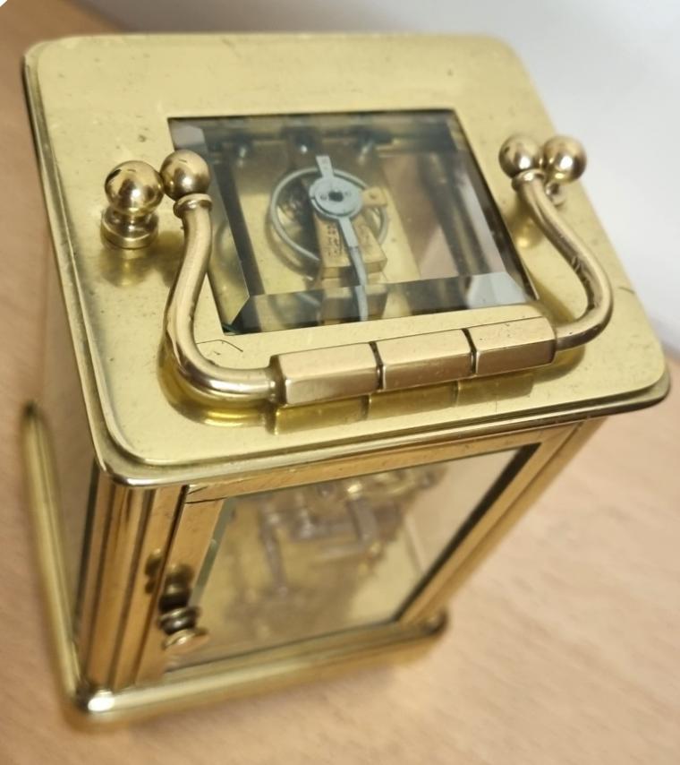 French gilt brass and 5 glass, 8 day miniature alarm carriage clock time piece circa 1900, maker unknown. Obis casework with chamfered glass panels throughout and gilt brass masked white enamel dial with black Arabic hours and black steel hands together with lower alarm time set indicator dial. Plain brass movement numbered 30105 with original cylinder escapement.     Height - 3.5" Width - 2.5" Depth - 2.25".