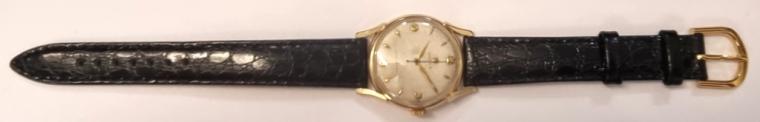 Rolex gents manual wind dress watch in a signed 9ct gold Dennison 'Made For Rolex' case hallmarked for Birmingham c1955, on a black leather strap with gilt buckle. Signed aged silvered dial with gold numeric and dart hours with gold luminous in-fill hands and blued steel sweeping centre seconds hand. Swiss Rolex signed 15 jewel jewelled lever calibre 710 movement with overcoil hairspring and numbered 29439 with case back numbered 12857 and 638687.