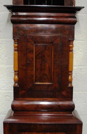 Imposing flame mahogany cased, grandfather longcase clock. Swan neck hood with contrasting light coloured turned wood pillars and further matching turned pillar case decoration. Painted face with subsidiary seconds and date display dials. Bell striking, 8 day movement circa 1850, signed to the dial R.Easby, Durham.