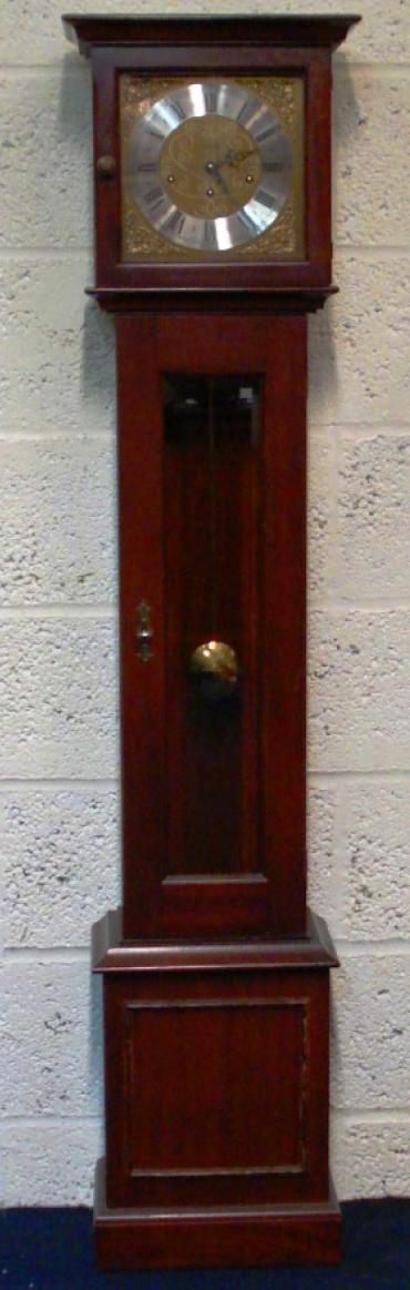 Modern mahogany finished, 8 day, spring driven Westminster chiming grandfather longcase clock by Metamec of Dereham. Pendulum movement with decorative brass face, silvered chapter ring, brass spandrels, black hands and black roman hour markers.