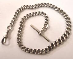 Silver graduated watch chain with 't' bar and snap c1900