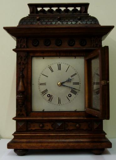 8 day Winterhalder and Hofmeier Ting Tang mantel clock circa 1900. Substantial architectural mahogany case with half turned pillars and other applied decoration throughout. Square wooden door with flat glass over heavily silvered brass dial plate with engraved black roman hours and minute track and ornate blued steel hands. Good quality square brass ting tang spring driven pendulum governed movement stamped 'D.R.Patent' (Deutsches Reich Patent) and 'W&H Sch' (Winterhalder & Hofmeier Schwarzenbach).
