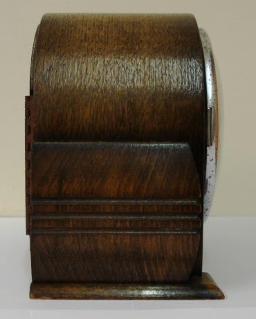 English 8 day oak veneer cased mantel clock timepiece circa 1930 by Davall, retailed by T.Pickford & Co. Round topped case with decorative side moulding, chromed bezel with convex glass over silvered chapter ring with black roman hours and chromed steel hands. Square brass spring driven movement with original Davall pendulum.