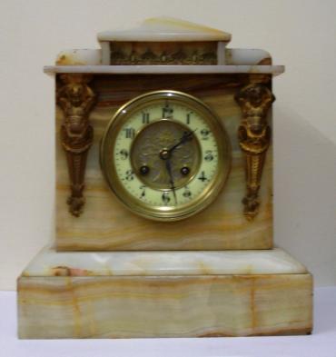 French 8 day white marble cased mantel clock circa 1890. Architectural square case with decorative applied ormolu mouldings and gilt circular bezel with flat chamfered glass over an ivory enamel chapter ring with silvered and gilt fretwork centre. Black gothic hours and ornate blued steel hands and slow / fast adjuster at 12 o/c. Good quality pendulum regulated, spring driven, gong striking French brass drum movement with an 'AD Mougin' 'Deux Medailles' touch mark and numbered #44.