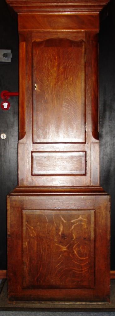 Clock for sale for restoration. English 30 hour oak and mahogany cased bell striking long case grandfather clock. Scrolling swan neck topped case with turned side columns, original glass over a aged painted dial, black roman hours and brass hands. Lacks pendulum and weight.