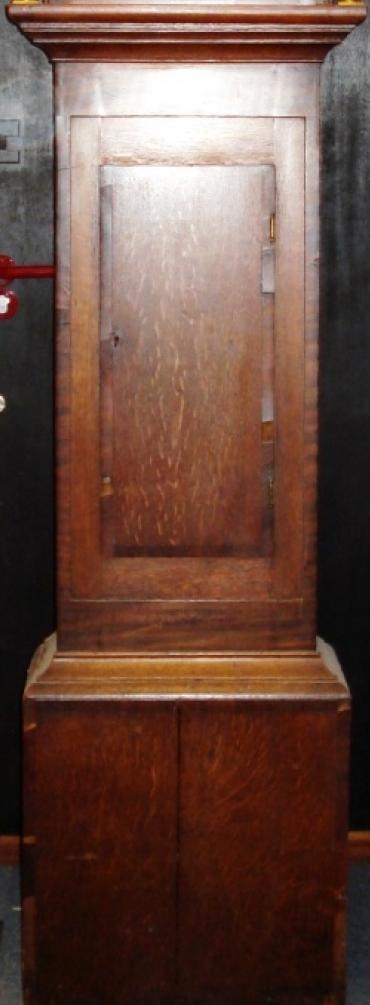 Clock for sale for restoration:- English 30 hour oak and mahogany cased bell striking longcase grandfather clock. Scrolling swan neck topped case with fluted side columns, crossbanded door with original glass over painted face with floral decoration. Black roman hours and brass hands. Lacks weight, pendulum and original backboard.