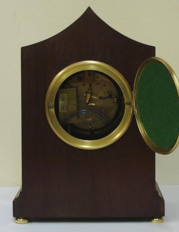 French 8 day walnut cased mantel clock striking on a gong, circa 1870. Elegant lancet topped case with extensive floral themed  marquetry inlay and  integral plinth with brass bun feet. Gilt brass bezel with convex  glass over an enamelled convex dial with black roman hours and black steel moon hands, slow / fast adjust at 12 o'clock. Ornate brass rear door with sound frets over a good quality French brass drum, spring driven pendulum regulated, movement by Vincenti. Movement and pendulum both numbered #66655 and the movement stamped with the Vincenti mark incorporating a 'Medaille d'Argent - 1855' award.