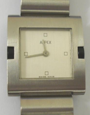 Modern quartz swiss made wrist watch by Alfex. Square brushed stainless steel case with matching integral bracelet and stainless steel back. White painted dial with quarter hour markers and silver coloured hands. Water resistant case with swiss made movement.