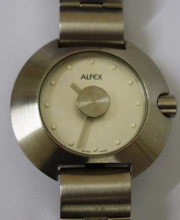Modern quartz swiss made wrist watch by Alfex. Brushed stainless steel case with matching integral bracelet and stainless steel back. Brushed stainless steel dial with polished spot hour markers and matt silver coloured hands. Water resistant case with swiss made movement.