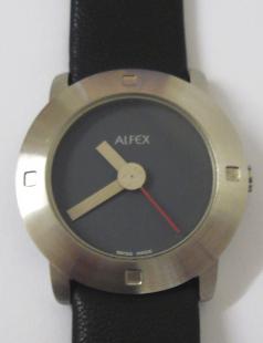 Modern quartz swiss made wrist watch by Alfex. Brushed stainless steel case water resistant to 3 atmospheres with a polished stainless steel back and on an original Alfex black leather strap. Dark coloured dial with matt stainless steel coloured hands and a red sweep seconds hand.