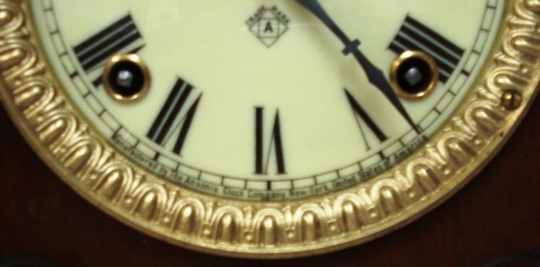American Ansonia Clock Company 'Sharon' 8 day mahogany veneer pine cased gong strike mantel clock circa 1890. Decorative architectural case with carved and applied moulding and ornate gilt bezel with flat, chamfered glass over an ivory coloured dial with black roman hours and blued steel hands with a slow / fast adjuster at 12 o/c. Good quality brass, spring powered, pendulum driven movement stamped for the Ansonia Clock Co. and displaying a patent date of June 18, 1882.