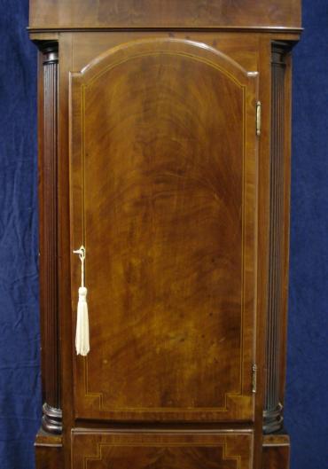 Flame mahogany and boxwood inlay cased longcase clock, with painted face and swan neck hood with fluted pillars.  Bell striking, 8 day movement, with seconds indication and date display, together with 'strike / silent' capability.   Dial signed W. HERBERT, LUDLOW