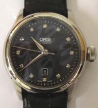 Oris 7604 Artelier All Stainless Steel Wristwatch Over A black Textured Dial