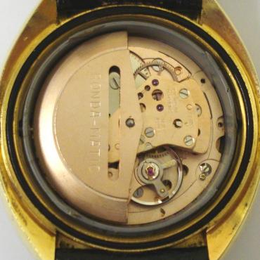 Cadilca Rondamatic automatic wrist watch in a gold plated case with a stainless steel back, on a black leather strap with gilt buckle. Gold coloured dial with gilt and black baton hour markers and matching hands with sweep seconds hand and day / date display at 3 o/c. Swiss made Rondamatic calibre 1239-21 17 jewel automatic incabloc movement with screw on case back.