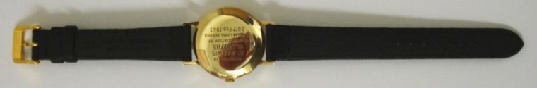 Smiths Everest manual wind presentation wrist watch in a 9ct gold case on a black leather strap with gilt buckle. Champagne dial with gilt arabic and baton hour markers and matching gilt hands with red tipped sweep seconds. Smiths 19 jewel calibre 0104 movement with snap on case back hallmarked for London 1961 and inscribed to Mr A LEWIS for 25 years with Smiths - February 1963 and with original fitted box.