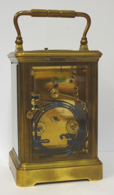 French gilt brass and 5 glass, 8 day strike / repeat carriage clock circa 1880 by Henri Jacot. Corniche case with chamfered glass panels throughout, white enamel dial with black Roman hours and minute track and blued steel hands. Back plate with Jacot arrow and numbered #6702 below a contemporary silvered jewelled lever escapement. 'Hidden' oval Henri Jacot stamp applied internally to the back of the dial plate.