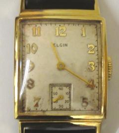 American Elgin manual wind wrist watch in a gold plated case with base metal back on a brown leather strap with gilt buckle. Silvered dial with gilt arabic hour markers and matching hands and subsidiary seconds dial. Signed 15 jewel movement numbered C667671 with case back numbered #7412317.