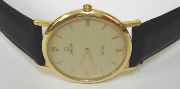 Omega De Ville Summit '92 Quartz wrist watch in an 18ct Gold case with black leather strap and gilt buckle. Champagne dial with gilt Roman quarters and baton hour markers and matching gilt hands. Case back is inscribed Summit '92 with initials and has a serial number #53554477 and is complete with original Omega presentation box.