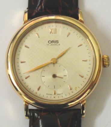 Oris 7423B Classic manual wind wrist watch in a gold plated case with stainless steel back on a dark red leather strap with gilt buckle. Silvered textured dial with gilt XII and dart hour markers with matching hands and subsidiary seconds dial at 6 o/c. Swiss made Oris SA 17 jewel incabloc movement with case water resistant to 30 metres.