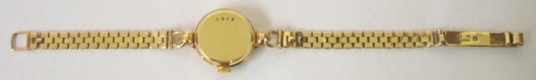 Ladies Swiss Jaeger LeCoultre manual wind wrist watch in a 9ct gold case with associated 9ct gold bracelet. Silvered dial with gilt Arabic and baton hour markers and matching gilt hands. Signed jewelled lever movement numbered #1183932 with case back numbered #6750. Watch case hallmarked for London circa 1956, bracelet Birmingham circa 1957.