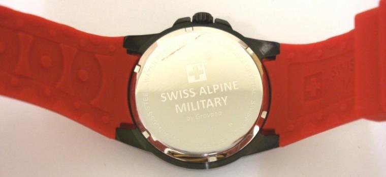 Brand new Swiss Alpine Military quartz wrist watch by Grovana in an all stainless steel black case with red rubber strap. Sapphire crystal over a black textured dial with luminous insert polished silver hours and matching hands, red seconds hand and date display at 3 o/c. Brand new model 7058.1LE watch number 1876 with screw down back water resistant to 100 metres complete with box, all paperwork and 2 year manufacturer's guarantee.