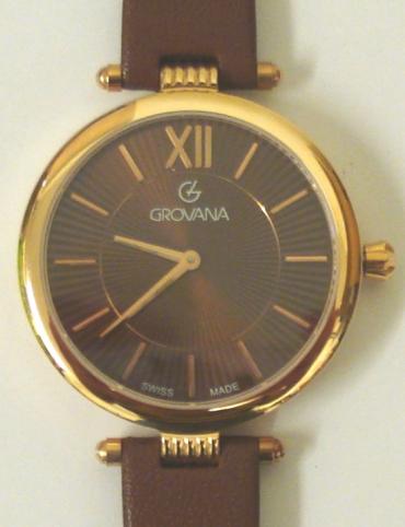 Brand new mid-size quartz wrist watch by Grovana in a gold plated case with stainless steel back and brown leather strap with gilt buckle. Sapphire crystal over a brown sunburst dial with polished gilt hours and matching hands. Brand new model 4450.1CK watch number 1566 water resistant to 50 metres complete with box, all paperwork and 2 year manufacturer's guarantee.