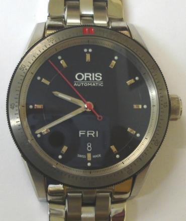 Oris 7662 Artex automatic wrist watch in an all stainless steel case with integral bracelet. Sapphire crystal over a black dial with polished silver hour markers and matching luminous insert hands, red sweep seconds and day / date display at 6 o/c. Oris High Mech 733 26 jewel automatic incabloc movement with screw down crown and screw on case back numbered 34-03097, water resistant to 100m.