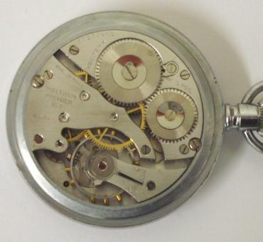 American Waltham Premier 16s WW2 military pocket watch. Black enamel dial with luminous Arabic hours with matching hands and subsidiary seconds dial at 6 o/c. Base metal case with screw on front and back with 9 jewel overcoil hairspring jewelled lever movement dating from c1942, adjusted for temperature and 3 positions and numbered #31271402. The case back is inscribed Keystone 731519 and bears a broad arrow mark numbered 1520.