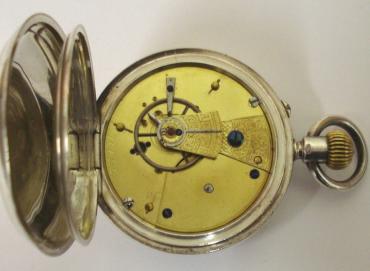 English silver cased open face pocket watch maker unknown, hallmarked for Chester c1897. White enamel dial with black Roman hours and gilt hour and minute hands. Top wind and rocking bar time change movement numbered #16695 with decorated cock piece and jewel end stone.