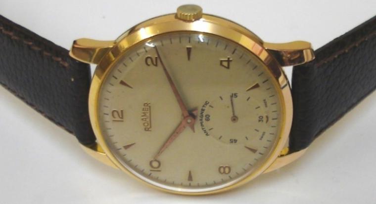 Swiss Roamer manual wind wrist watch on a brown leather strap with gilt buckle. Gold plated case with stainless steel back numbered #6841 with silvered dial. Gilt Arabic and dart hour markers with matching hands and subsidiary seconds dial. Signed Swiss 15 jewel jewelled lever movement calibre MST402.