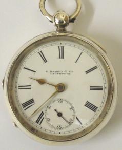 English lever silver cased pocket watch by E.Harris of Liverpool with Birmingham hallmark for 1892. Key wind and time change, white enamel dial with black Roman hours and gilt spear and shaft hands. Engraved back plate signed and numbered #226332 with engraved cock piece and jewelled end stone.