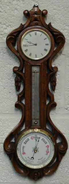 Late 19th century carved oak cased French 8 day timepiece with 'tic tac' movement, mercury thermometer, and aneroid barometer.