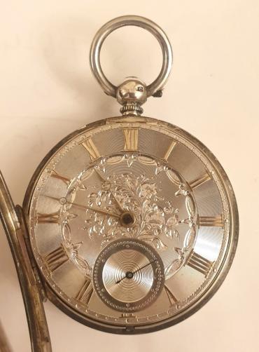 English silver cased key wound fusee pocket watch with London hallmark for circa 1855. Silver engine turned and floral engraved dial with gilt Roman hours and matching Breguet style hands with subsidiary seconds dial at 6 o/c. Decoratively engraved cock piece with diamond end stone and unsigned back plate numbered #9410 with a further three wheels jewelled.