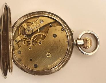 Swiss silver cased pocket watch, maker unknown. Top wind and rocking bar time change with white enamel dial and black Roman hours with black steel hands and subsidiary seconds dial. Unsigned Swiss 3/4 plate movement with cylinder escapement and case back bearing a London import hallmark for circa 1912 and numbered #69986.