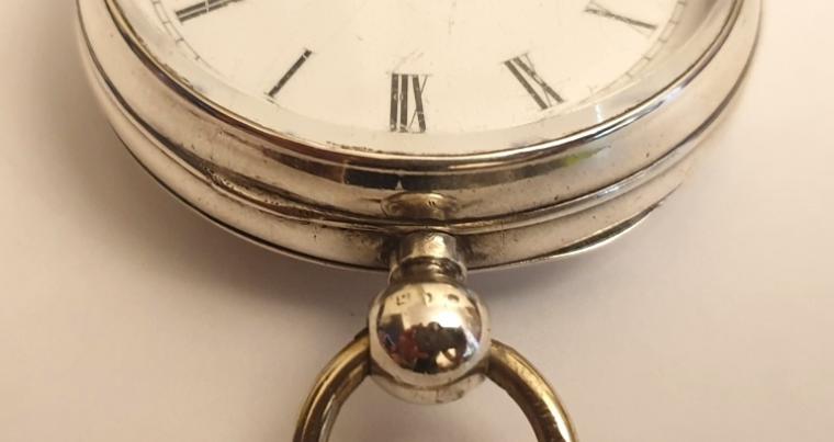 Swiss silver cased pocket watch made by the Swiss Watch Co. in an English case bearing a Birmingham hallmark for circa 1891. Key wind and time change with white enamel dial and black Roman hours with gilt hands and subsidiary seconds dial. Signed Swiss jewelled lever escapement with going barrel movement numbered #271648, the case back stamped 'LJ' and numbered #1811.