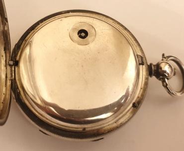 English silver cased pocket watch by Kendal & Dent, London in a case bearing a Birmingham hallmark for circa 1896. Key wind and time change with signed white enamel dial and black Roman hours with gilt hands and subsidiary seconds dial. Signed going barrel movement with floral decorated cock piece and jewelled end stone and with inscription '106 Cheapside, London' and numbered #82226, the number repeated on the case back with the 'K&D' stamp.