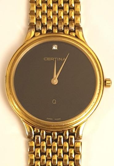 Modern Swiss quartz dress watch by Certina. Gold plated case over stainless steel with matching integral bracelet and a stainless steel back. Sapphire crystal over a matt black dial precious gem set at 12 o/c with polished gilt angular pointed hands, case water resistant to 50m. and complete with original retail box and papers.
