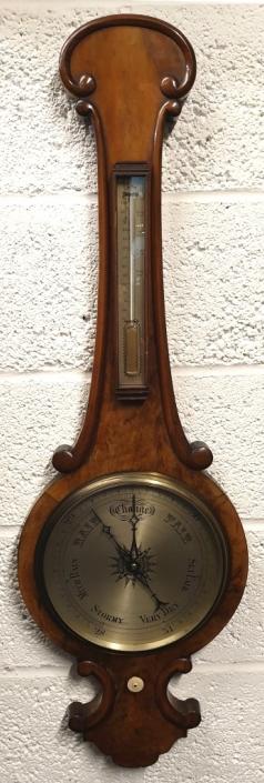 C19th mahogany cased mercury wheel barometer with decorative edge moulding. Circular gilt brass bezel with flat glass over a silvered dial with black inches of mercury pressure index and blued steel pressure indicating hand with a brass history marker which is manually adjusted by the lower ivory coloured wheel. Complete with a separate silvered dial Fahrenheit thermometer.  Dimensions: - Height 1200mm, width 330mm.