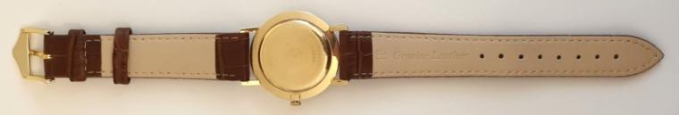 Rolex Tudor manual wind wrist watch in a 9ct gold case with brown leather strap and gilt buckle. Champagne dial with black insert baton hours and matching polished gilt hands and sweep seconds hand. Signed Tudor calibre ETA 2750 17 jewel movement in a signed 9ct gold case with a London import hallmark for 1975, model 9801 and numbered 609245.