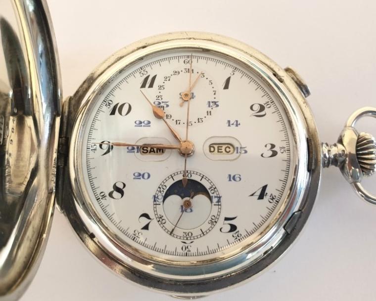 Extremely rare Swiss silver cased full hunter triple complication pocket watch probably made by Le Phare in Le Loc in the early 1900s. White enamel dial with gilt hands and date pointer at 12, day and month apertures at 9 and 3, small seconds at 6 and moon phase, with black Arabic hours and blue 24hr markers. Swiss hand wound jewelled lever movement with side piece for setting hands, a side pusher located at 6 for minute repeat function on two gongs and chronograph pusher at 2. The chronograph is a single push piece with pillar wheel system with centre seconds recording hand. The silver case is numbered 129048 and marked as 0.925 silver and bears the maker's mark 'A&C'.
