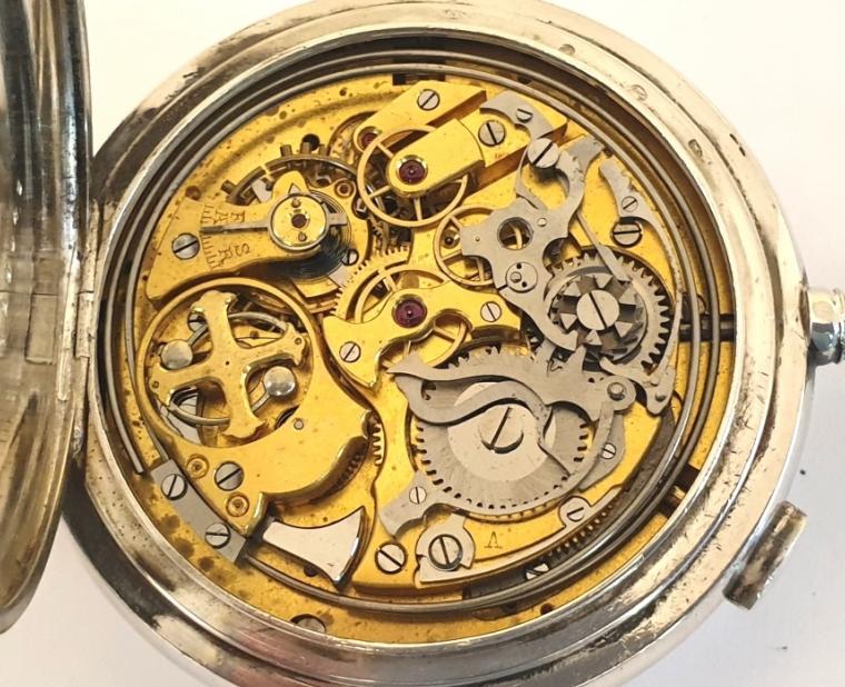 Extremely rare Swiss silver cased full hunter triple complication pocket watch probably made by Le Phare in Le Loc in the early 1900s. White enamel dial with gilt hands and date pointer at 12, day and month apertures at 9 and 3, small seconds at 6 and moon phase, with black Arabic hours and blue 24hr markers. Swiss hand wound jewelled lever movement with side piece for setting hands, a side pusher located at 6 for minute repeat function on two gongs and chronograph pusher at 2. The chronograph is a single push piece with pillar wheel system with centre seconds recording hand. The silver case is numbered 129048 and marked as 0.925 silver and bears the maker's mark 'A&C'.