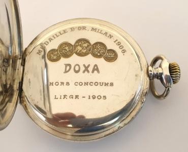 Swiss silver cased pocket watch by Doxa circa 1910. Top wind and time change with painted dial displaying an erotic scene with black Arabic hours in white surrounds and gilt hands. Signed 0.800 silver case numbered 628173 with signed jewelled lever movement with bi-metallic balance.