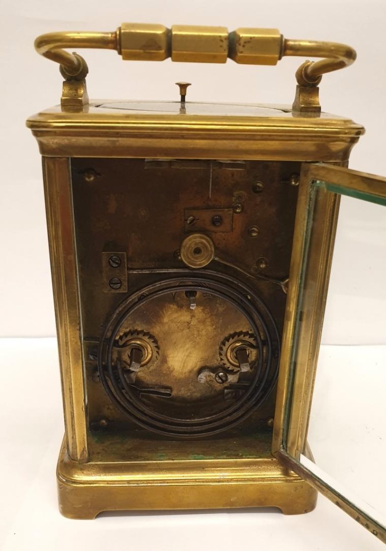 French gilt brass and 5 glass, 8 day carriage clock circa 1900, striking and repeating on a gong. Obis casework with chamfered glass panels throughout and gilt brass masked white enamel dial with black Arabic hours and black steel hands together with gilt dial centre. Plain brass movement with original silvered lever escapement platform.    Height - 6" Width - 3.75" Depth - 3.25".